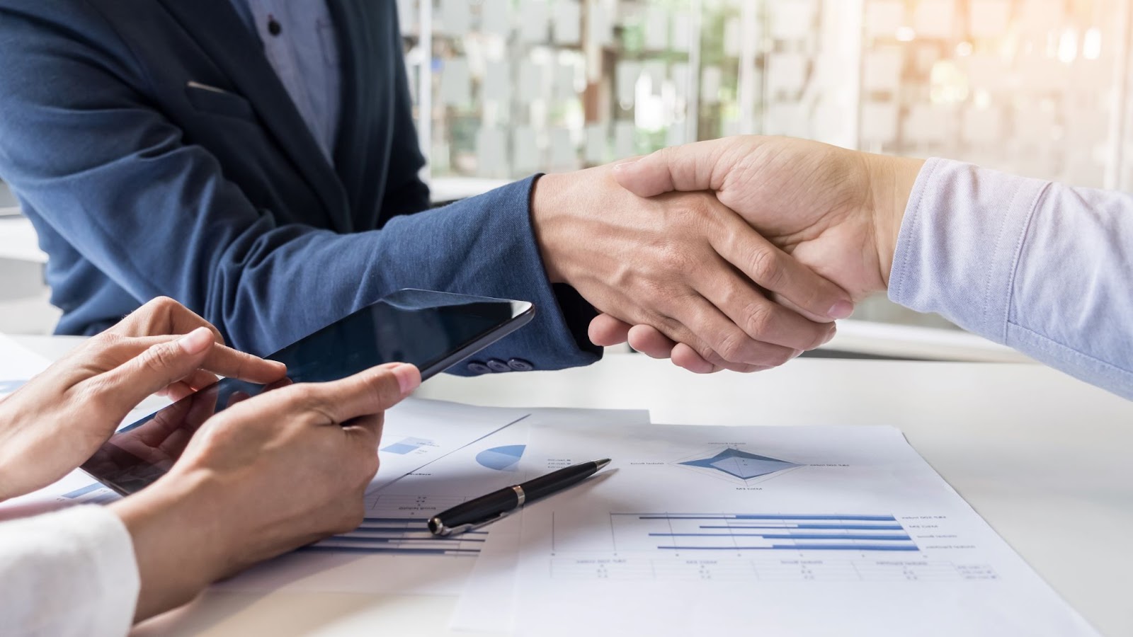 business-handshake-of-two-men-demonstrating-their-agreement-to-sign-agreement-or-contract-between-their-firms-companies-enterprises.jpg